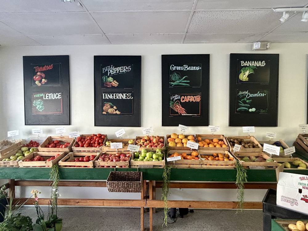 MacDill Fresh produce display with hand-painted chalkboard signs